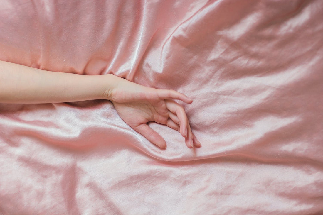 Hand laid across silk bedding